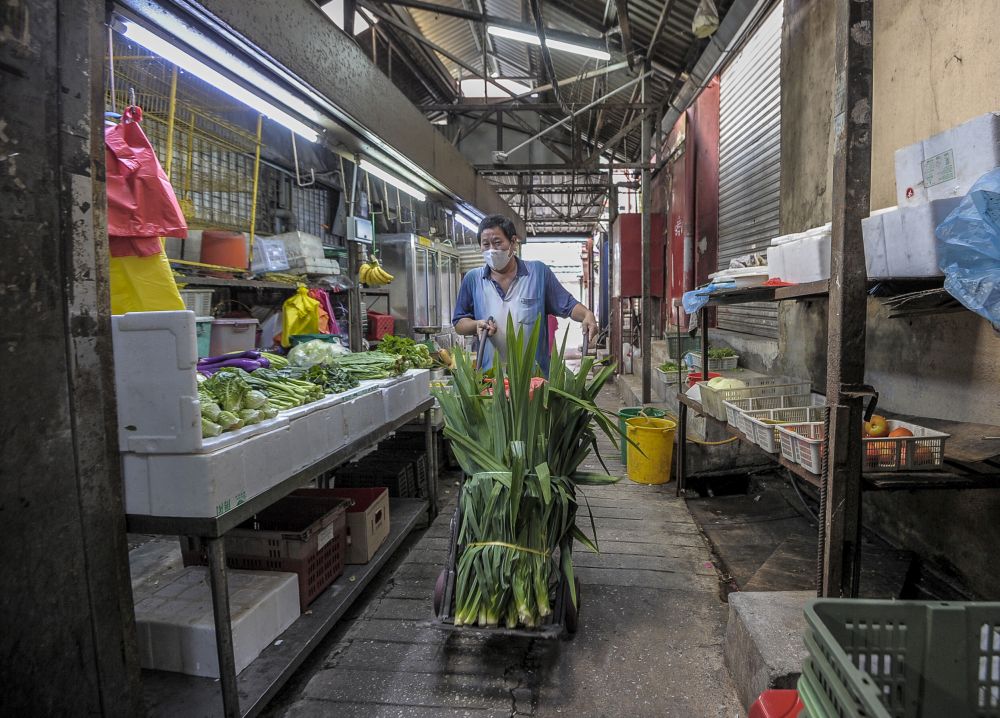 A trader is pictured at the Petaling Street wet market on the first day of the conditional movement control order in Kuala Lumpur, May 4, 2020. u00e2u20acu201d Picture by Shafwan Zaidon