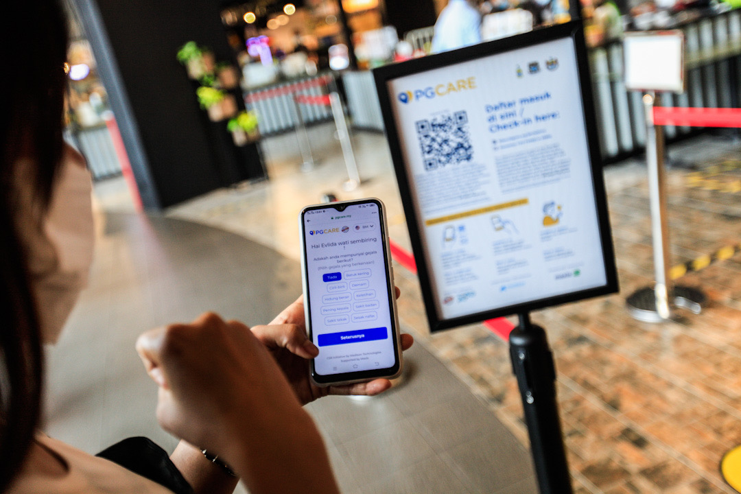 Members of the public are pictured using the PGCare app at the Queensbay Mall in Penang May 18, 2020.  u00e2u20acu201d Picture by Sayuti Zainudin