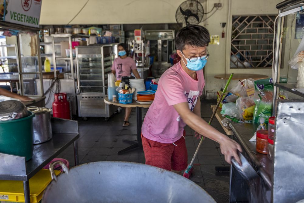 A man gets to work at his food stall in a coffeeshop after the enhanced movement control order was lifted in Petaling Jaya Old Town May 21, 2020. u00e2u20acu201d Picture by Shafwan Zaidon