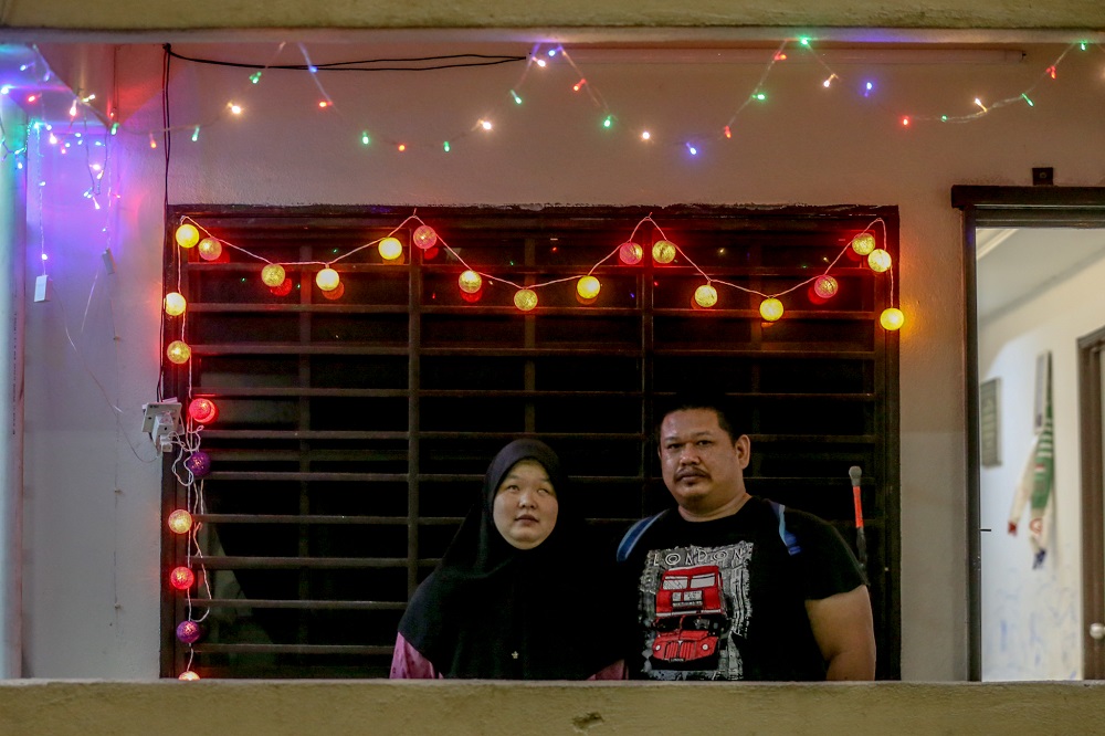 Endi Susilo Tasiron and his wife Nur Alia Maisarah Ong Abdullah pose for photo during an interview at their home in PPR Lembah Subang 2.