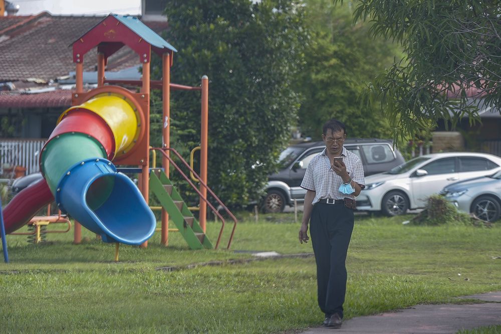 A man takes a morning walk at the playground during the movement control order in Seri Serdang, May 3, 2020. — Picture by Shafwan Zaidon