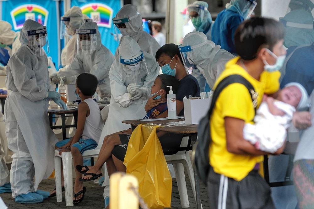 Residents undergo swab tests during a Covid-19 screening exercise in Pudu, Kuala Lumpur May 15, 2020. u00e2u20acu201d Picture by Ahmad Zamzahuri