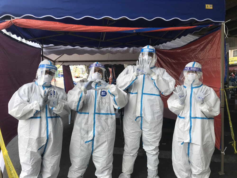 Several health workers get ready at the Covid-19 screening area at the Pudu Market in Kuala Lumpur May 5, 2020. u00e2u20acu201d Picture by Radzi Razak