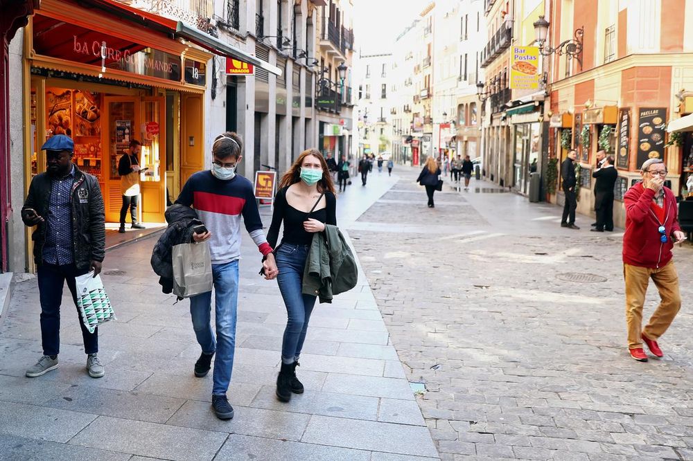 A couple wear protective face masks as they walk in unusually quiet Postas street in central Madrid, Spain, March 13, 2020. u00e2u20acu201d Reuters pic