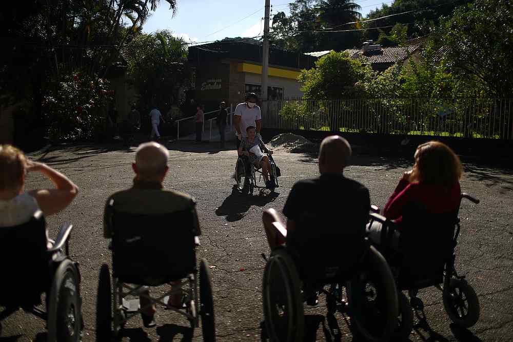 A health worker takes elderly persons to sunbath in the Retiro dos Artistas (Artists Retirement) nursing home in Rio de Janeiro, Brazil May 25, 2020. u00e2u20acu201d Reuters pic