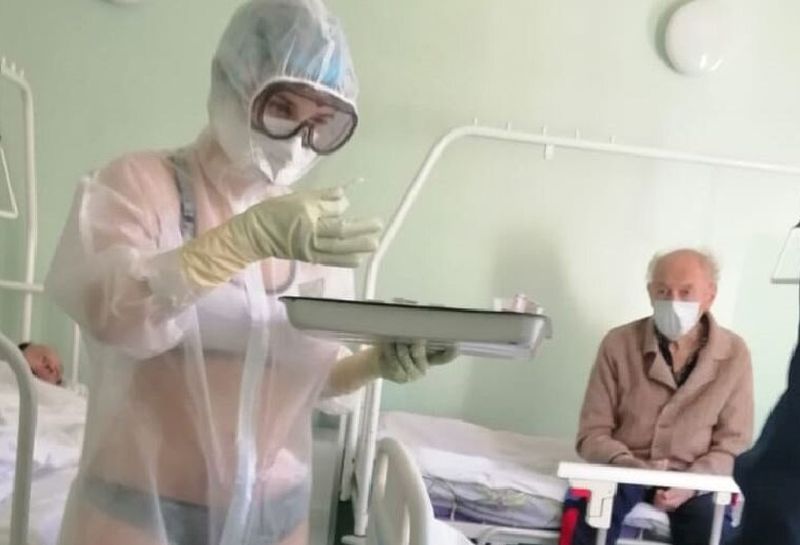The viral image of a Russian nurse in what appears to be a bikini treating Covid-19 patients in a male-only ward. u00e2u20acu201d Picture via Twitter/_MariettaDavis