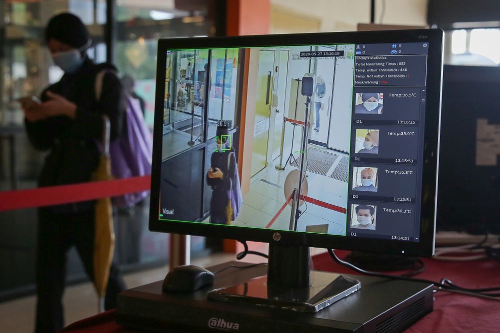 A security personnel monitors thermal scanners as patrons enter the 1Utama shopping mall in Petaling Jaya May 28, 2020. u00e2u20acu201d Picture by Yusof Mat Isa