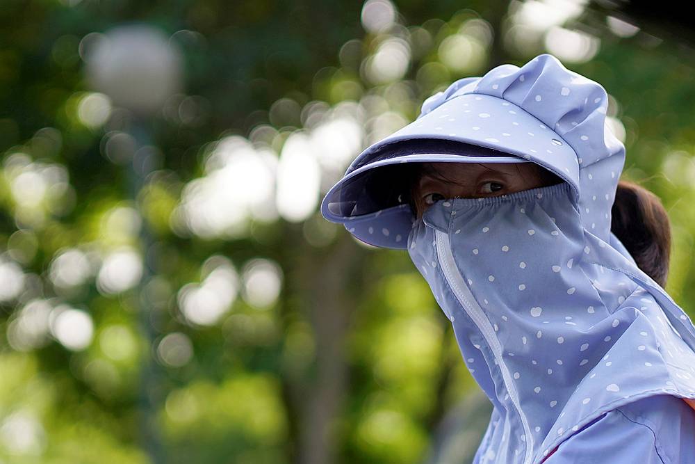 A woman wearing a face mask is seen on a street following an outbreak of Covid-19, in Shanghai, China May 13, 2020. u00e2u20acu201d Reuters pic
