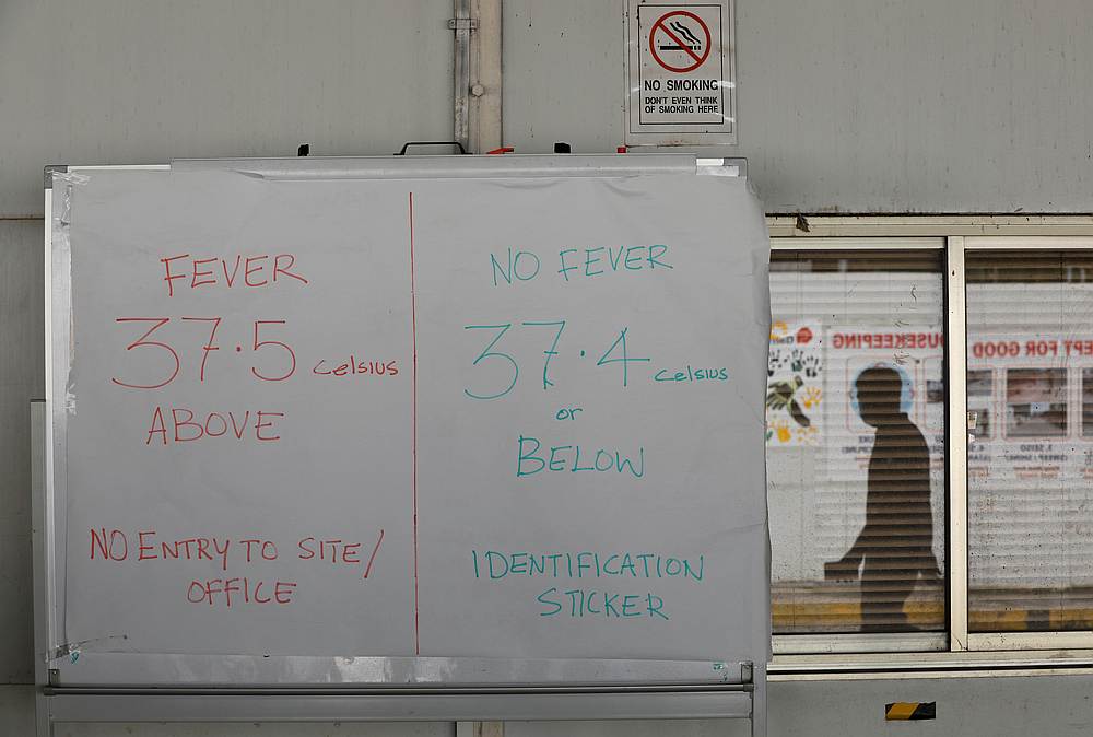 A sign with instructions on temperature taking is pictured in a construction site amid the Covid-19 outbreak in Singapore May 5, 2020. u00e2u20acu201d Reuters pic 