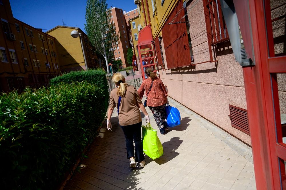 Cristina (right) and Maria Jose, volunteers with the Nazaret Association, carry food rations to be distributed to people in need in Madrid on May 24, 2020. u00e2u20acu201d AFP pic