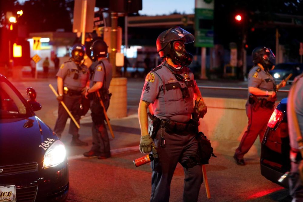 Police officers face protesters after a white police officer was caught on a bystanderu00e2u20acu2122s video pressing his knee into the neck of African-American man George Floyd, who later died at a hospital, in St Paul, Minnesota, US May 28, 2020. u00e2u20acu201d Reuters pic