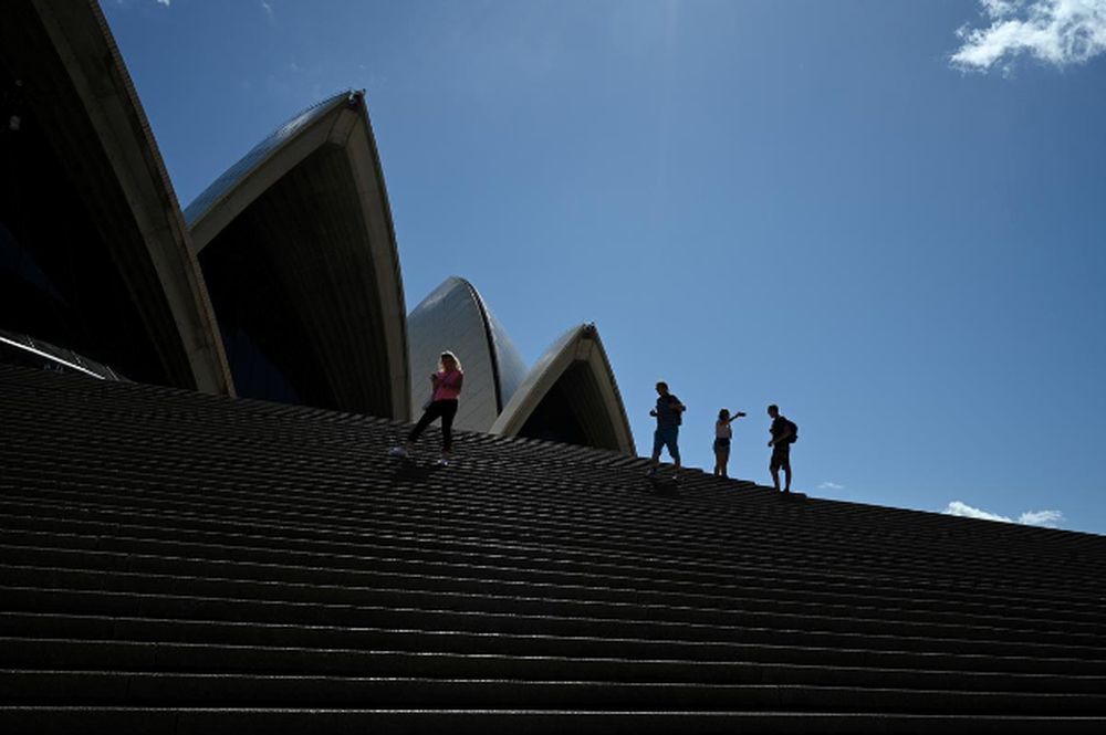 A handful of tourists stand atop the mostly deserted steps of the Sydney Opera House, where scheduled public performances have been cancelled due to the coronavirus disease (Covid-19), in Sydney, Australia, March 18, 2020. u00e2u20acu201d Reuters pic