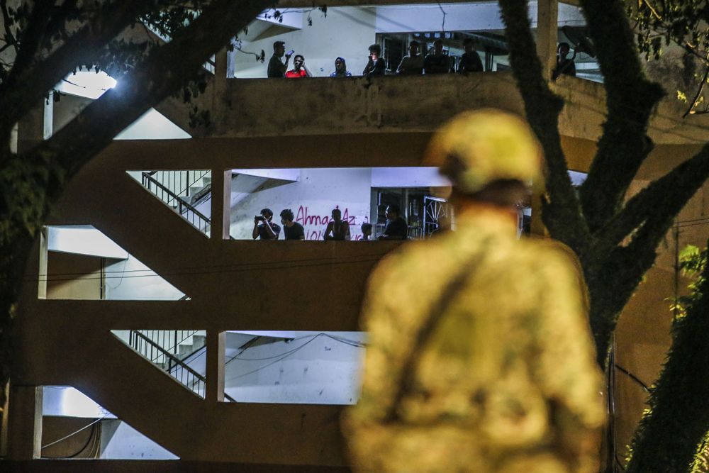 Residents of a low-cost apartment building in Taman Wilayah Selayang look out from their balcony after the area was placed under the enhanced movement control order May 4, 2020. — Picture by Hari Anggara