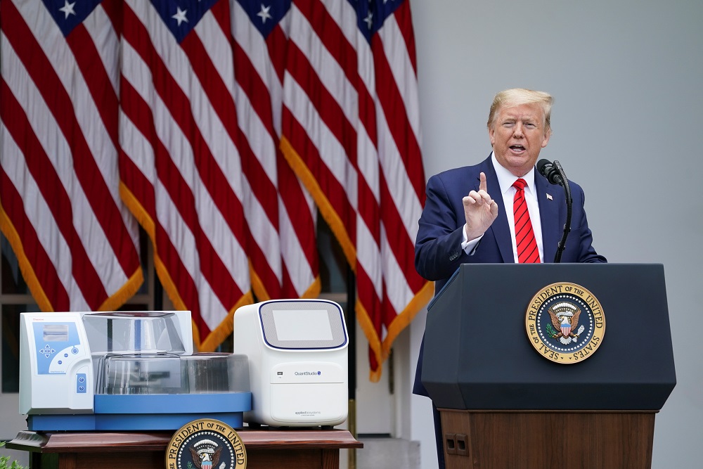 US President Donald Trump stands next to coronavirus disease testing machines as he addresses a Covid-19 outbreak press briefing at the White House in Washington May 12, 2020. u00e2u20acu2022 Reuters pic 