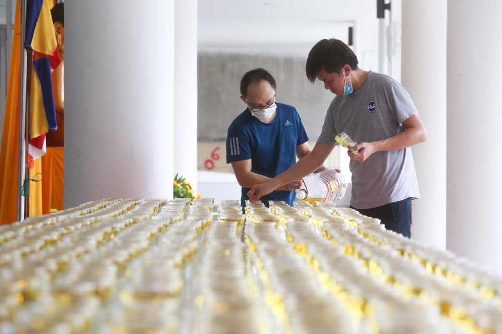 Volunteers set up oil lamps that will be lighted up during Wesak on Wesak eve at the Buddhist Maha Vihara in Brickfields, May 6, 2020. u00e2u20acu201d Picture by Choo Choy May