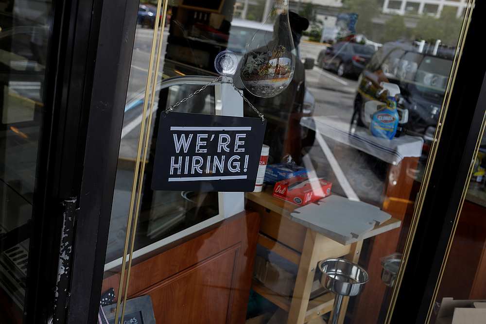 A 'We're Hiring' sign advertising jobs is seen at the entrance of a restaurant in Miami, Florida May 18, 2020. u00e2u20acu201d Reuters pic