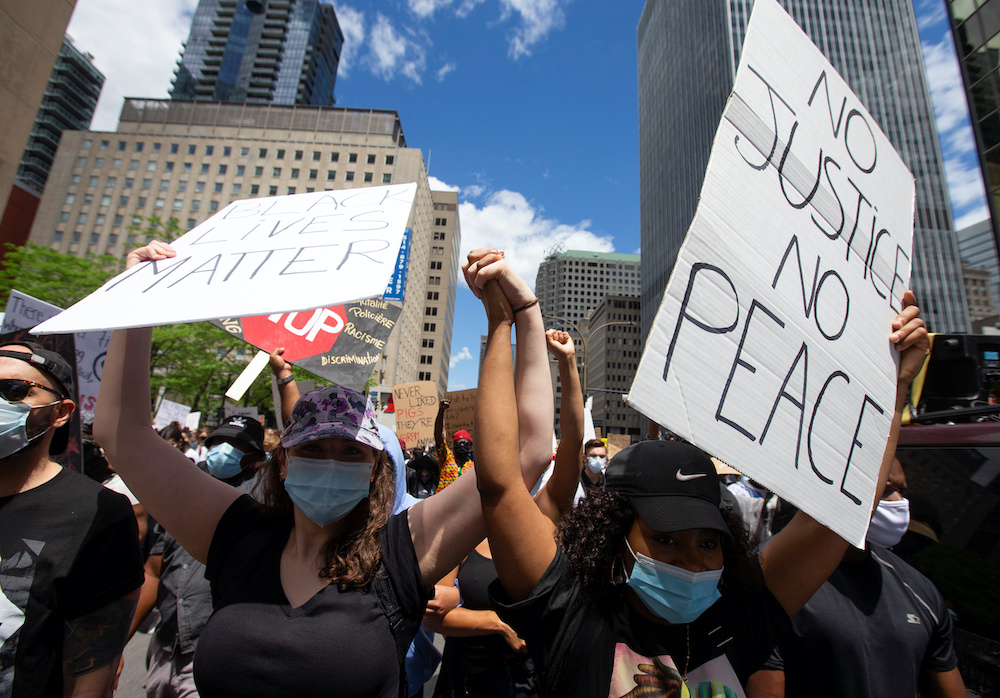 People hold signs as they participate in a protest against racial inequality and police brutality in the aftermath of the death in Minneapolis police custody of George Floyd, in Montreal, Quebec, Canada June 7, 2020. u00e2u20acu201d Reuters pic