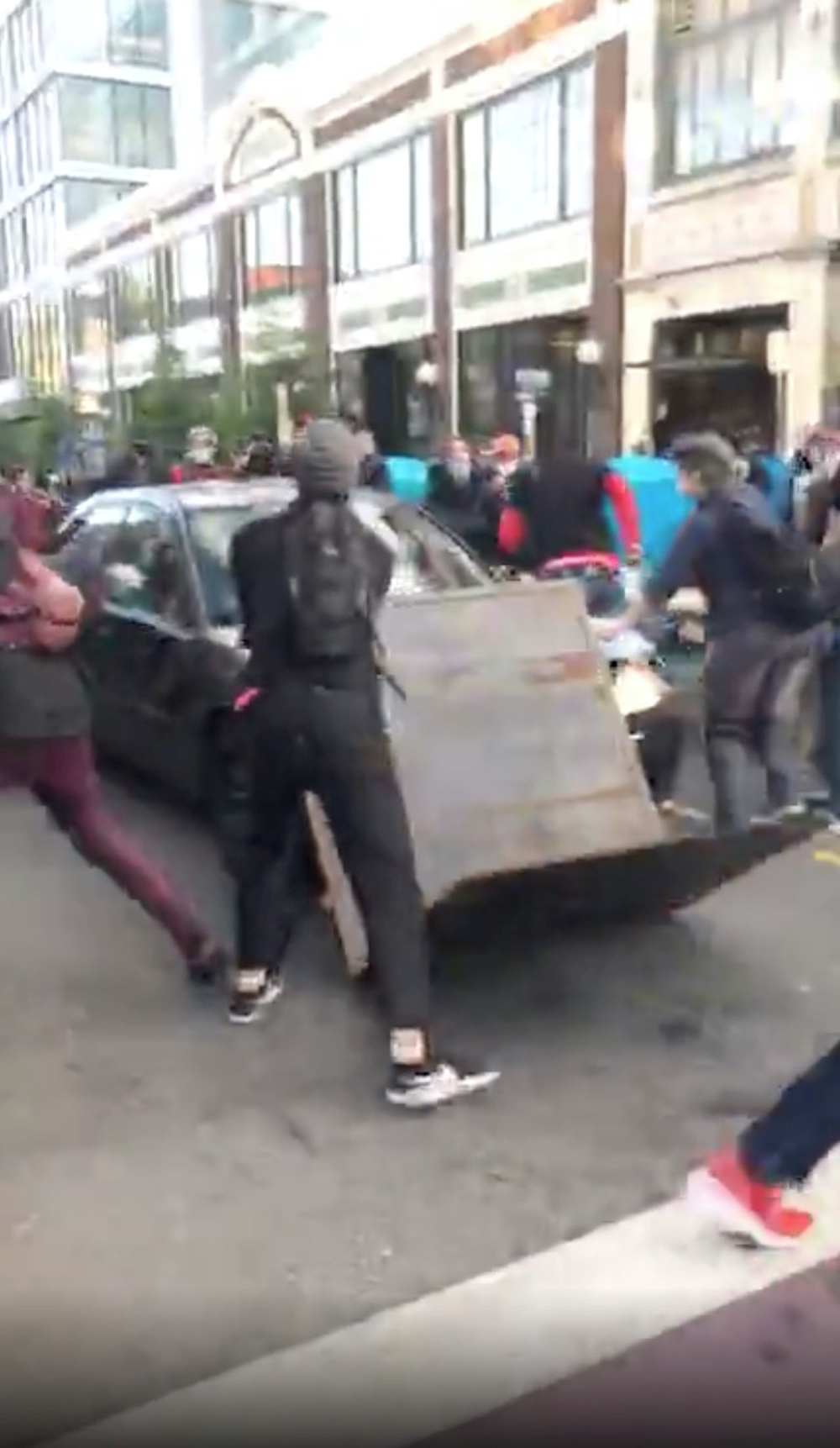 A car crashes into a barricade set up by protesters, moments before a man exits the vehicle holding a gun, in Seattle, Washington June 7, 2020, in this still image taken from video obtained from social media. u00e2u20acu201d Brooke Wynalda handout via Reuters