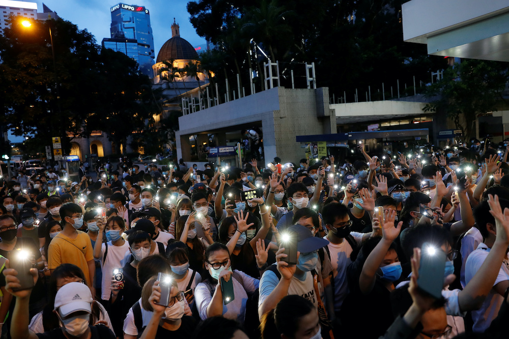 Pro-democracy demonstrators march holding their phones with flashlights on during a protest to mark the first anniversary of a mass rally against the now-withdrawn extradition bill, in Hong Kong, China June 9, 2020. u00e2u20acu201d Reuters pic