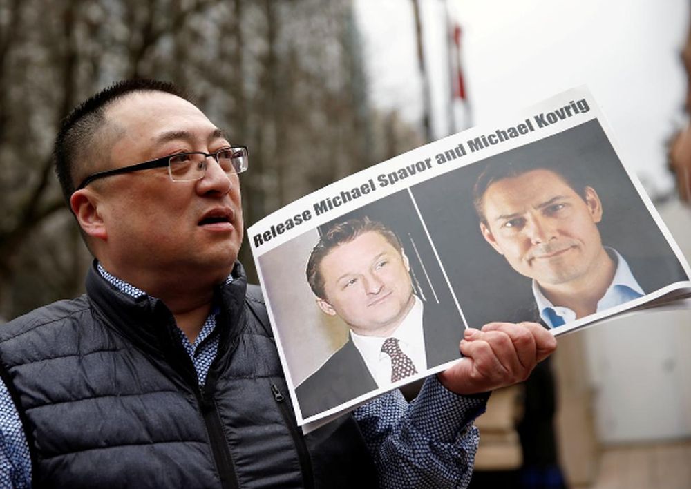 Louis Huang holds a placard calling for China to release Canadian detainees Michael Spavor and Michael Kovrig outside a court hearing for Huawei Technologies Chief Financial Officer Meng Wanzhou at the BC Supreme Court in Vancouver, Canada, March 6, 2019.