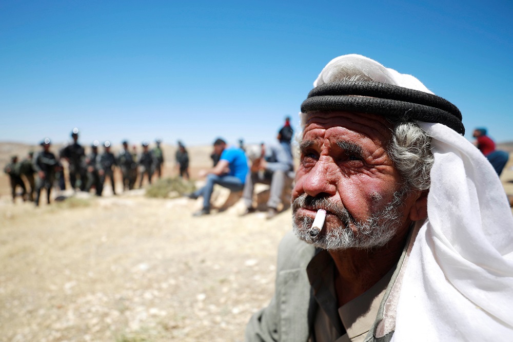 A Palestinian man smokes a cigarette during a protest against Israeli machineries operating near Ramallah in the Israeli-occupied West Bank May 26, 2020. u00e2u20acu201d Reuters pic
