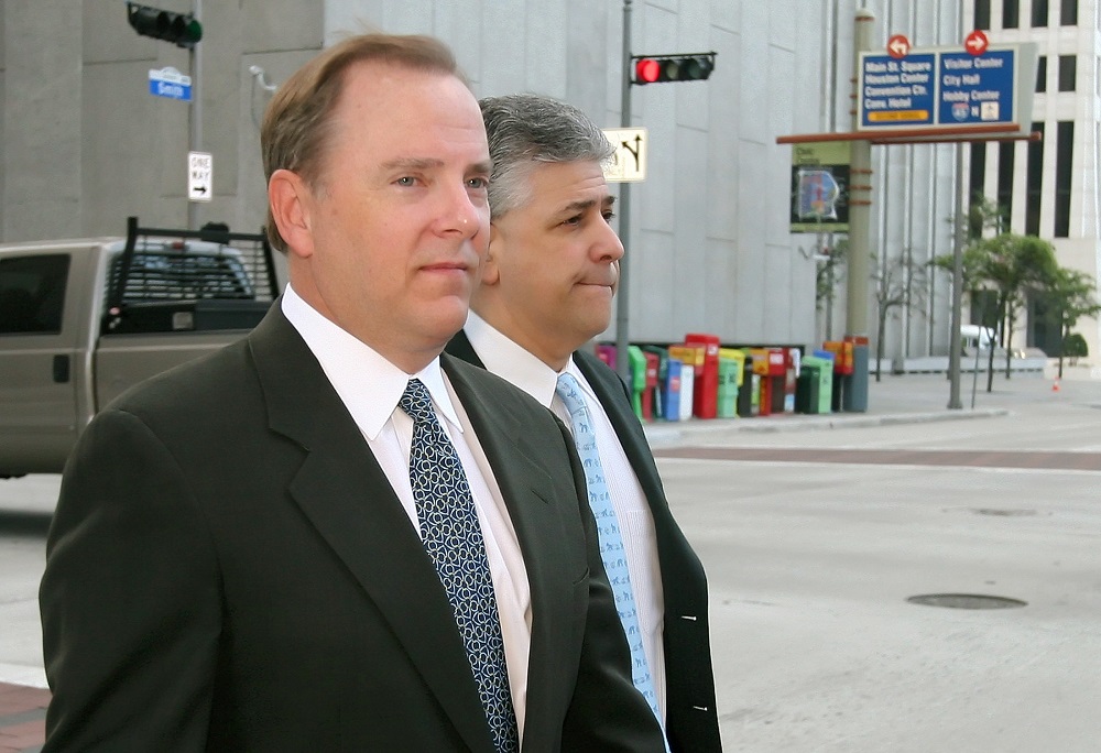 Former Enron CEO Jeffrey Skilling (left) and attorney Daniel Petrocelli cross the street as they arrive at the Federal court in Houston April 13, 2006. u00e2u20acu201d Reuters pic