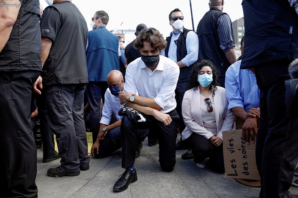 Canadau00e2u20acu2122s Prime Minister Justin Trudeau wears a mask as he takes a knee during a rally against the death in Minneapolis police custody of George Floyd, on Parliament Hill, in Ottawa, Ontario June 5, 2020. u00e2u20acu201d Reuters pic