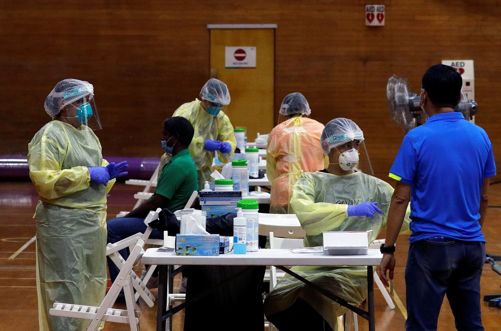 Essential workers have their noses swabbed before returning to the workforce at a regional screening centre, amid the Covid-19 outbreak in Singapore June 10, 2020. — Reuters pic