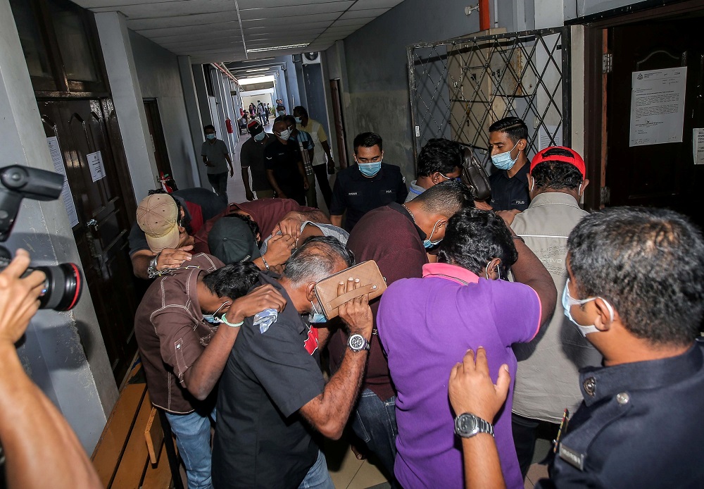 The 12 individuals arrested for gathering at a pub during the CMCO period are seen at the Magistrate Court in Ipoh June 1, 2020 u00e2u20acu201d Picture by Farhan Najib