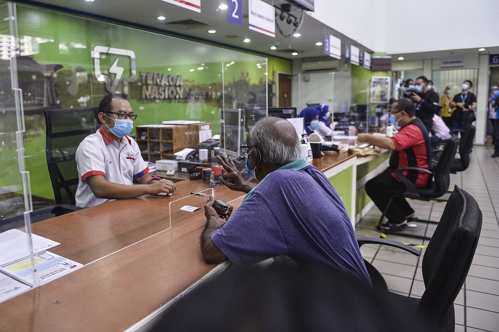Customers paying their bills at the Kedai Tenaga branch in Shah Alam June 2, 2020. u00e2u20acu201d Picture by Miera Zulyana