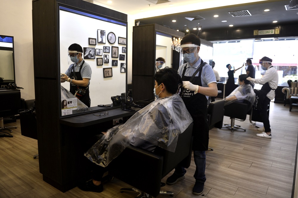 Hairdressers are seen working at the K Concept hair salon in Publika, Kuala Lumpur June 10, 2020. u00e2u20acu201d Picture by Miera Zulyana