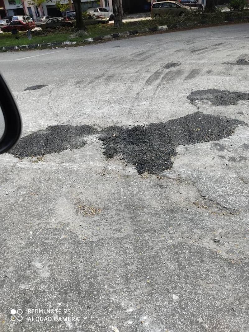 The tombstone has successfully pressured authorities to take action against the pothole. —Photo courtesy of Facebook/ Brotherhood Shah ALam