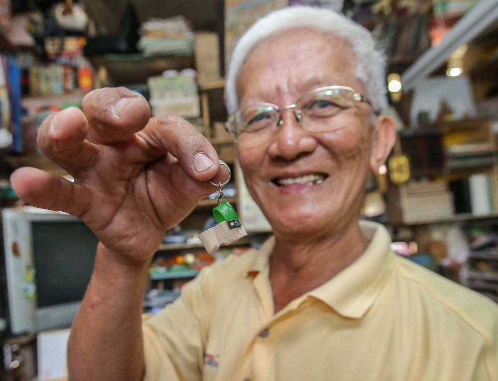 A miniature clog key chain made from recycled wood and plastic collected from unwanted clogs given by mosques. Wee gives out these key chains as souvenirs when he performs at fund raising activities. — Picture by Farhan Najib