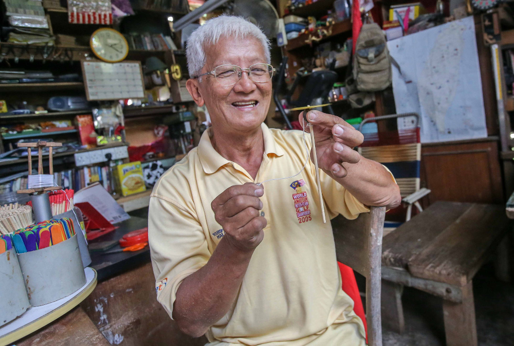 Retired headmaster Wee Ong Chin’s home at Sitiawan doubles up as his workshop where he prepares toys and souvenirs to be given out when he performs at charity events. — Picture by Farhan Najib 