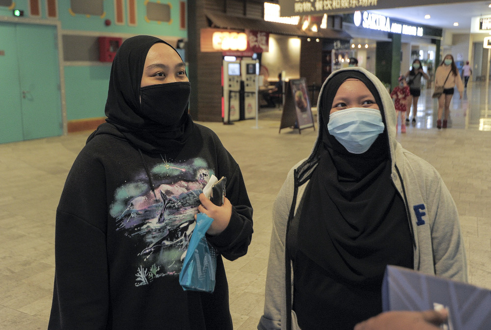 Jasmine (left) and colleague Mimi are glad RWG are going the extra mile to ensure the safety of visitors and staff June 19, 2020. 