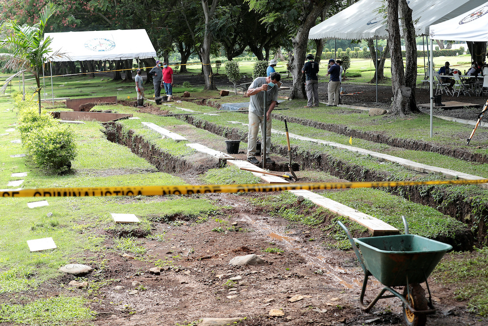 Employees work to exhume bodies at a private cemetery as part of a search for victims of the 1989 invasion by the US military action to topple strongman Manuel Noriega, in Panama City, Panama June 16, 2020. u00e2u20acu201d Reuters picn n