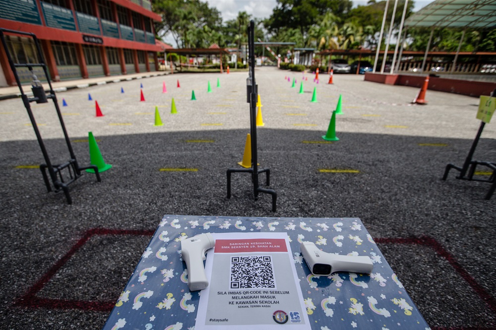A makeshift check-in station is seen at Sekolah Menengah Kebangsaan (SMK) Seksyen 19, where students are required to scan a QR code and record their temperatures before entering the school premises, in Shah Alam June 23, 2020. u00e2u20acu201d Picture by Firdaus Latif