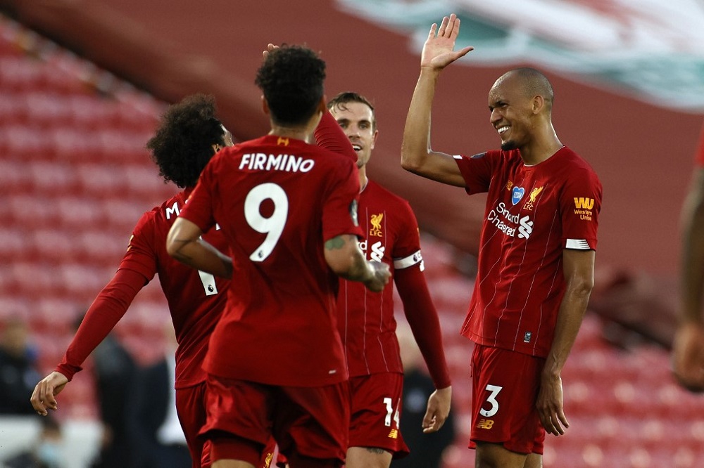 Liverpool's Brazilian midfielder Fabinho (right) celebrates scoring his team's third goal during the English Premier League football match between Liverpool and Crystal Palace at Anfield in Liverpool June 24, 2020. u00e2u20acu201d AFP pic