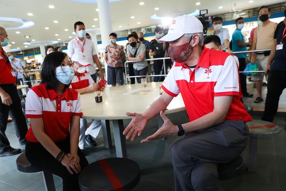 Progress Singapore Party member Lee Hsien Yang (right) speaking to fellow party member Wendy Low during a breakfast meeting at Tiong Bahru Market, June 24, 2020. u00e2u20acu201d TODAY pic