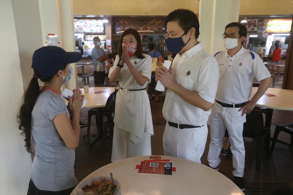 Lawrence Wong (second from right) with Peopleu00e2u20acu2122s Action Party candidates Hany Soh Hui Bin and Ong Teng Koon during a walkabout in Marsiling-Yew Tee Group Representation Constituency, June 28, 2020. u00e2u20acu201d TODAY pic
