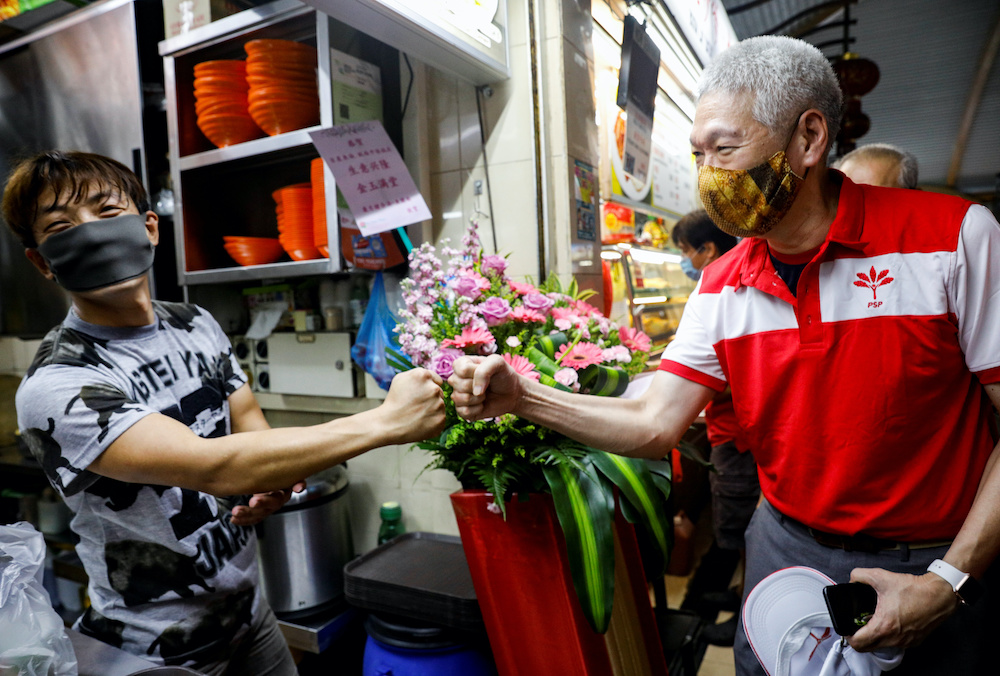 Lee Hsien Yang of the Progress Singapore Party (PSP) greets a hawker during a walkabout ahead of the general election in Singapore June 28, 2020. u00e2u20acu201d Reuters pic