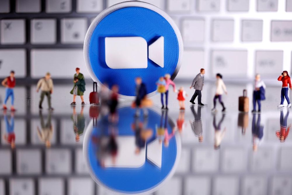 A 3D printed Zoom logo is placed between small toy people figures and a keyboard in this illustration taken April 12, 2020. u00e2u20acu201d Reuters pic