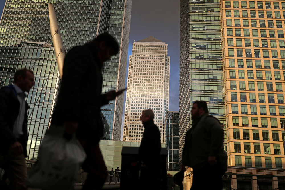 People walk through the Canary Wharf financial district of London, Britain, December 7, 2018. u00e2u20acu201d Reuters