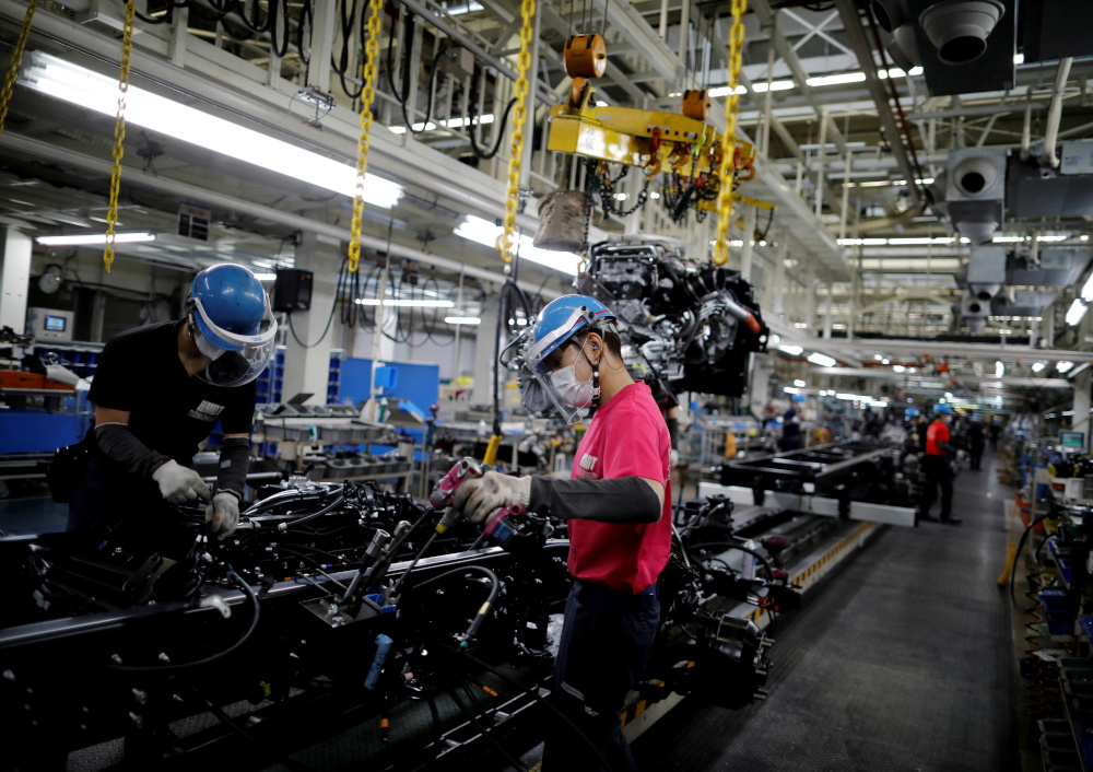 Employees work on the automobile assembly line during the outbreak of the coronavirus disease at Kawasaki factory of Mitsubishi Fuso Truck and Bus Corp, owned by Germany-based Daimler AG, in Kawasaki, south of Tokyo, Japan May 18, 2020. u00e2u20acu201d Reuters pic 