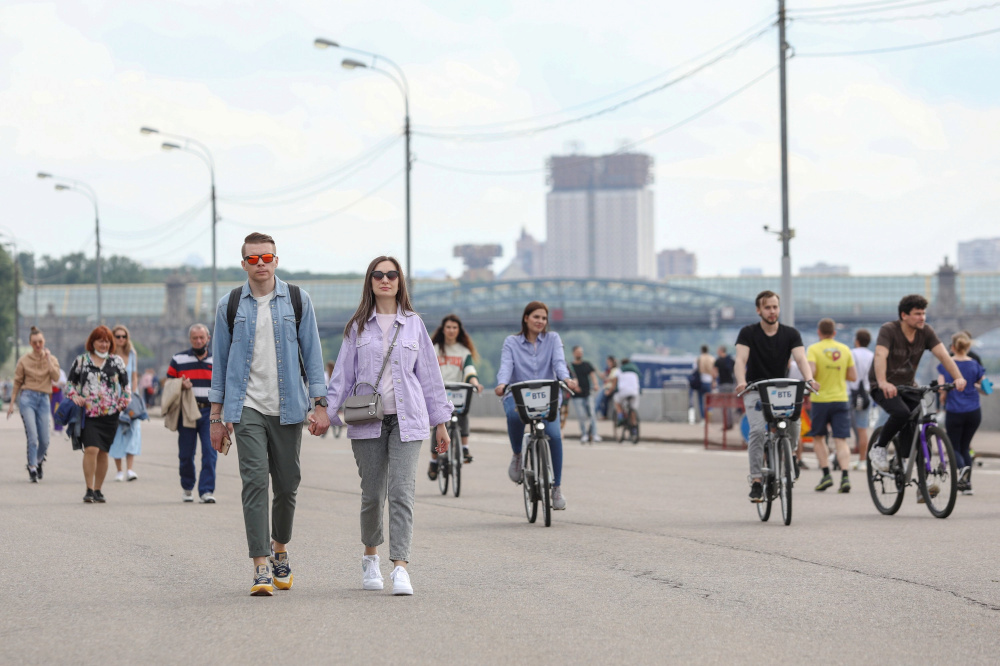 People walk and ride bicycles along an embankment of the Moskva River after local authorities partially lifted quarantine restrictions imposed to prevent the spread of Covid-19, in Moscow, Russia June 6, 2020. u00e2u20acu201d Kirill Zykov/Moscow News Agency handout p