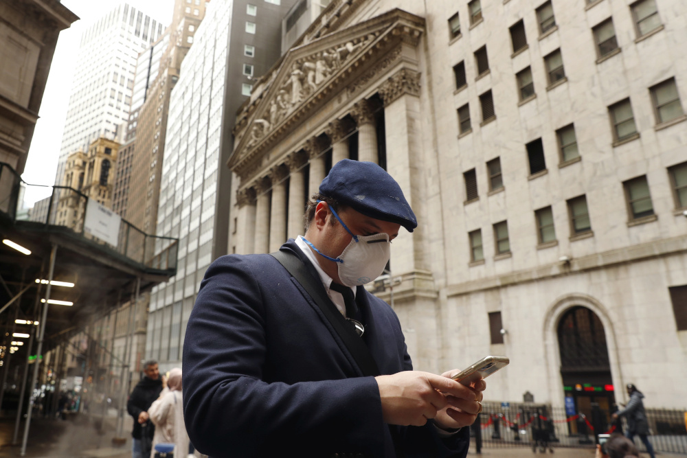 A man wears a protective mask as he walks past the New York Stock Exchange on the corner of Wall and Broad streets during the coronavirus outbreak in New York City, New York, US, March 13, 2020. u00e2u20acu201d Reuters pic