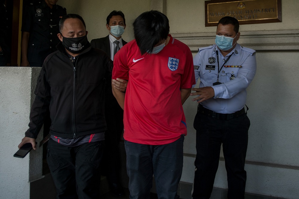 Khor Yong Zhang (centre) is led out of the Magistrate Court in Kuala Lumpur June 1, 2020. u00e2u20acu201d Bernama pic