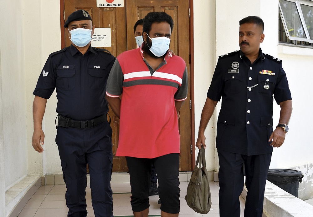 Omar Abdul Latif (centre) arrives in handcuffs at the Magistrateu00e2u20acu2122s Court in Kuala Kubu Baru June 9, 2020. u00e2u20acu201d Bernama pic