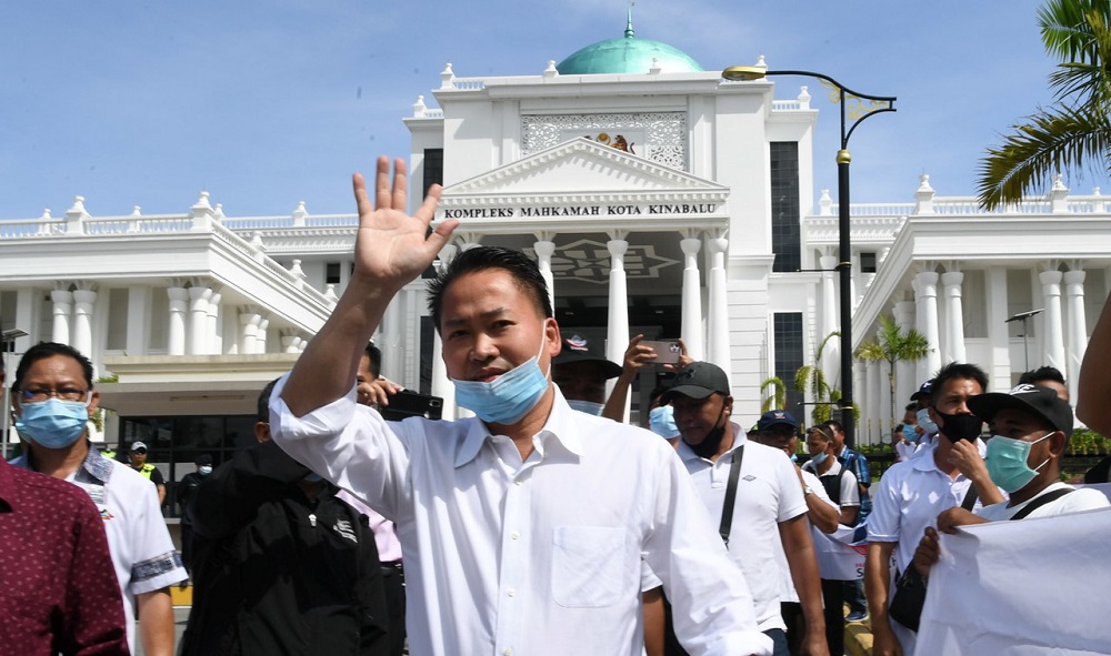 Sabah Infrastructure Development Minister Datuk Peter Anthony waves at supporters as he leaves the Special Corruption Court in Kota Kinabalu June 18, 2020. u00e2u20acu201d Bernama pic