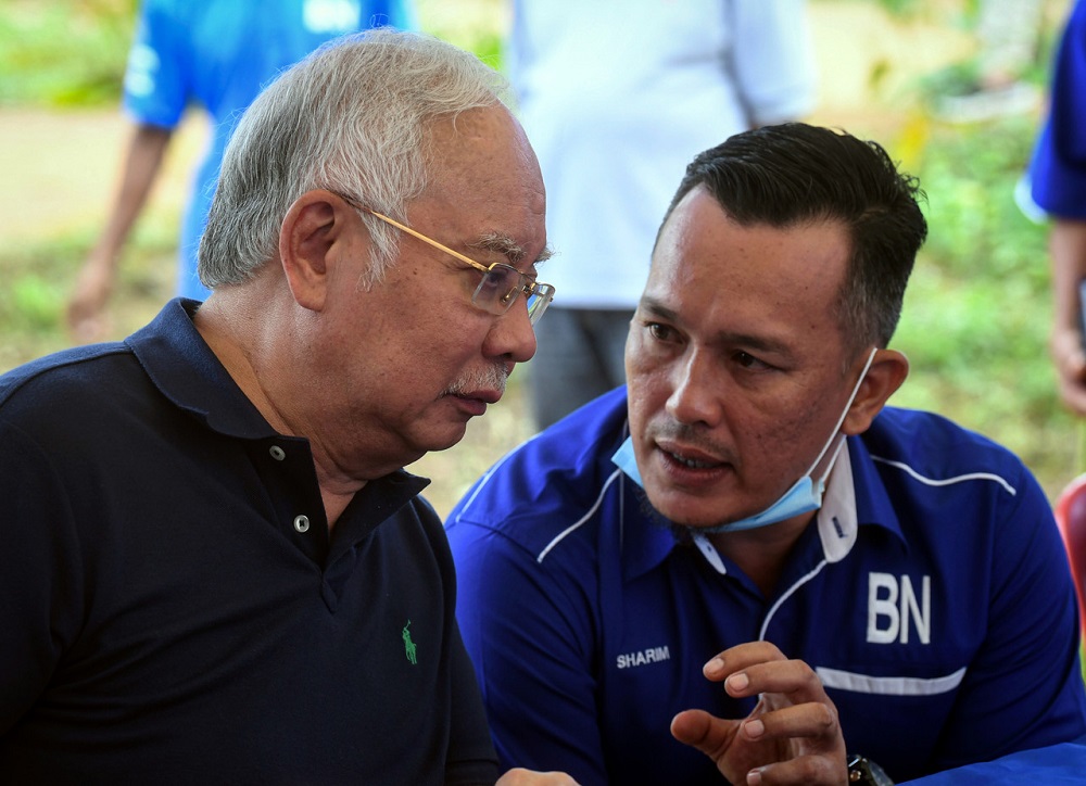 Datuk Seri Najib Razak (left) and Barisan Nasionalu00e2u20acu2122s candidate for the Chini by-election Mohd Sharim Md Zain are seen chatting during a visit the the Jakun Orang Asli settlement near Pekan June 25, 2020. u00e2u20acu201d Bernama pic